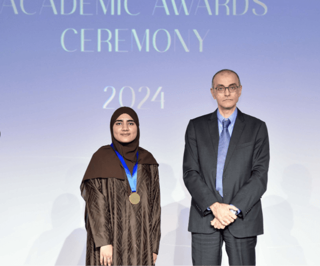 Ayesha receiving a medal on stage at the UDST Academic Awards Ceremony 2024