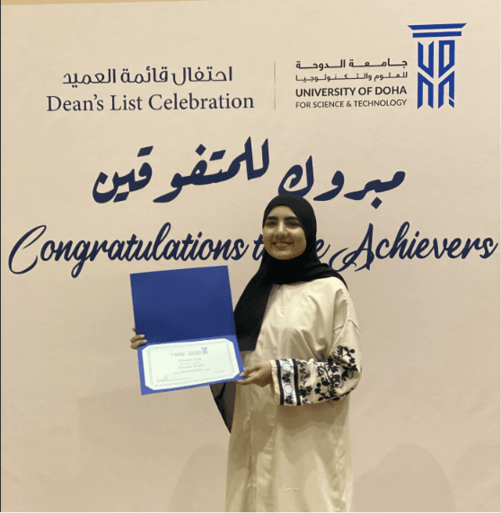 Ayesha holding her certificate at the UDST Dean's List celebration