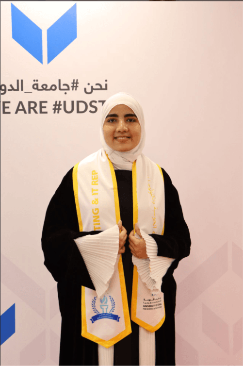 Ayesha wearing the Computing & IT Representative sash at a UDST event